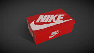 深灰色背景上帶有白色標誌的紅色Nike鞋盒。