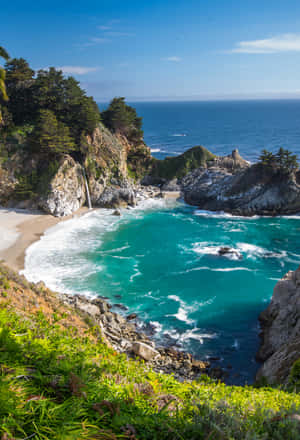 在清澈的藍天下，碧綠的海水和岩石懸崖的海岸小海灣。