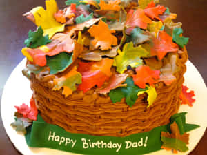 生日蛋糕，裝飾有秋葉和一條寫著Happy Birthday Dad的綠色絲帶