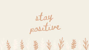 米色背景上帶有葉子邊框的勵志語句 stay positive