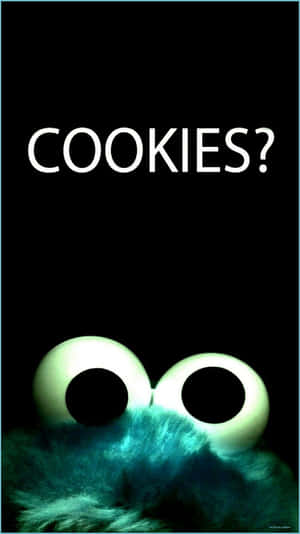 Cookie Monster 發光的眼睛在黑色背景上問『COOKIES?』