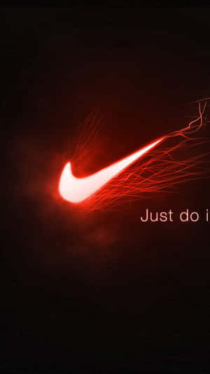 發光的紅色Nike剔號帶有火熱軌跡及「Just do it」文字在深色背景上。 — 型格 Nike 壁紙