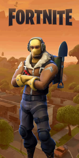 戴著黃色面具和藍色裝備的Fortnite角色交叉雙臂站立。 — 要塞英雄 大逃殺 壁紙