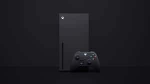 黑色 Xbox Series X 主機和控制器放在深色表面上。 — Xbox GIF 壁紙