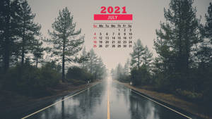 一條濕漉漉的森林道路，有高大的松樹和2021年7月的日曆疊加。