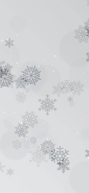 銀色雪花在灰色背景上伴隨散景燈光飄落。