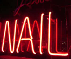在黑暗的酒吧或俱樂部中，紅色霓虹燈牌寫著「NAIL」。 — 霓虹 壁紙