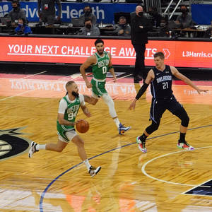 波士頓塞爾特人球員在NBA比賽中運球越過奧蘭多魔術防守球員。