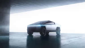 未來感十足的銀色電動卡車在光線明亮的混凝土車庫中。 — Tesla GIF 壁紙
