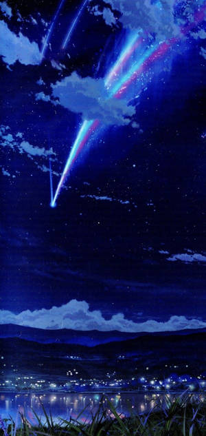 發光的流星劃過星空，湖面倒映著村莊的燈光。 — iPhone 11 壁紙
