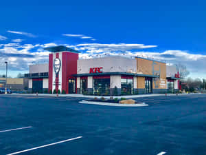 KFC餐廳，山德士上校畫像，藍天白雲下。