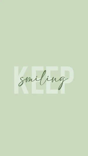 鼠尾草色背景上以白色和綠色顯示的勵志語句 'KEEP smiling'。