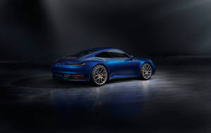 藍色保時捷911 Turbo S在黑暗工作室中被聚光燈照亮。 — 藍色 壁紙