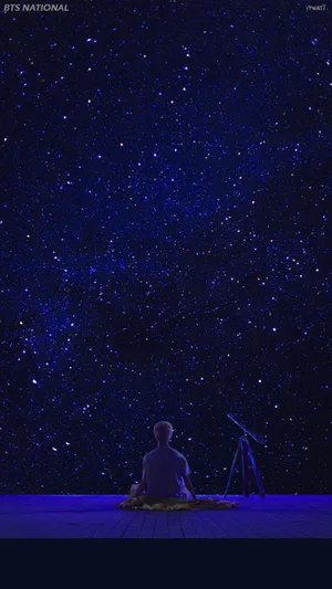 人坐在甲板上星空下與望遠鏡