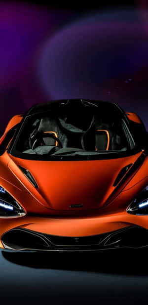 橙色McLaren跑車，車頭燈閃爍發光，在宇宙紫色背景下。 — 美學 壁紙