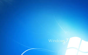 Windows 7 操作系統標誌在藍色漸變背景上，帶有發光的漩渦。
