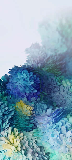 藍色、綠色和黃色的彩色分層紙花在朦朧的背景中。 — Samsung S23 Ultra 壁紙