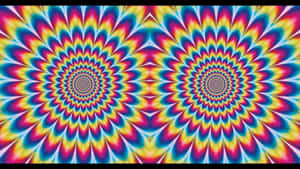 色彩繽紛的催眠螺旋圖案，帶有重複的彩虹形狀。 — 幻覺 壁紙