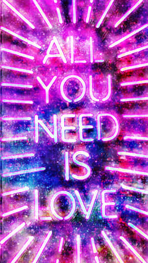 在宇宙背景上發光的霓虹文字「All You Need Is Love」。 — 霓虹 壁紙