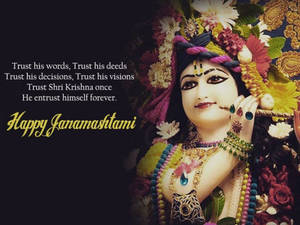 克里希納神手持長笛，被鮮花和 Janamashtami 的節日文字環繞。 — 勵志語錄 壁紙
