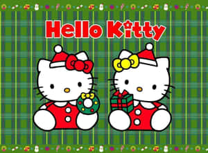 兩個穿著節日服裝的Hello Kitty角色，在格子背景上拿著花環和禮物。 — 可愛聖誕動圖 壁紙