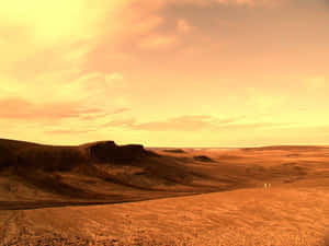 兩個人在夕陽下穿越廣闊嘅橙色沙漠。 — 火星 GIF 壁紙