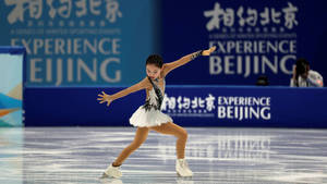 在北京比賽期間，年輕女性花樣滑冰運動員在冰上表演。