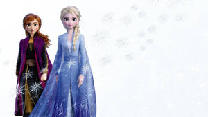 《魔雪奇緣》的安娜和愛莎身穿冬日服裝，雪花在他們周圍飄落。
