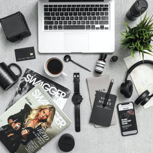 Minimalist desk setup with laptop coffee and tech gadgets
