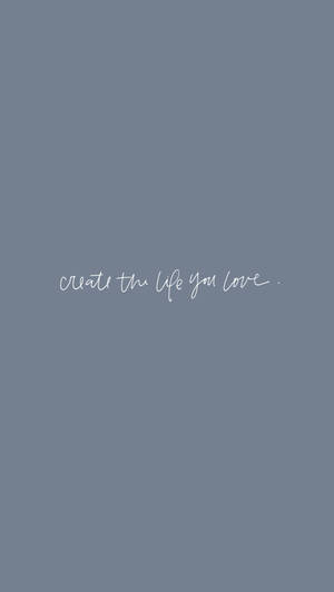 灰色背景上寫有白色草書文字「create the life you love」