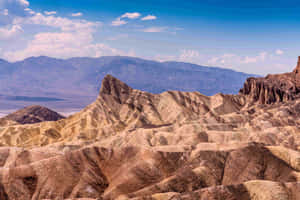 崎嶇的沙漠峽谷，層狀岩石結構，在明亮的藍天下。