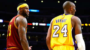 兩位NBA傳奇人物穿著球衣在籃球場上對峙。