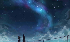 兩個人欣賞帶有發光宇宙雲的星空夜空。