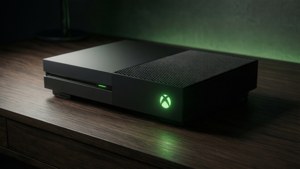 黑色 Xbox One 主機在黑暗房間的木桌上發出綠光。