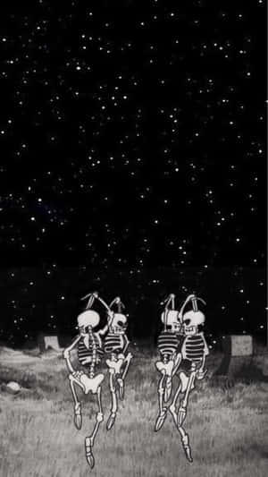 兩個骷髏在星空下的墓園裡跳舞。