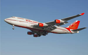 印度航空波音747飛機在藍天中飛行，起落架已放下