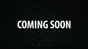 粗體白色文字寫著 COMING SOON，位於一個類似太空的深色斑點背景上。