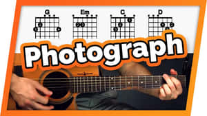 彈奏木結他的手，帶有和弦圖和「Photograph」文字。