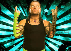 摔角手 Jeff Hardy 帶有紋身和綠色手臂繃帶，在藍綠色星爆背景前。