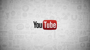YouTube 標誌，背景有微弱的極客主題圖標。