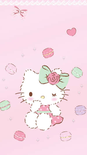 Hello Kitty 被馬卡龍和心形圖案包圍在粉紅色背景上