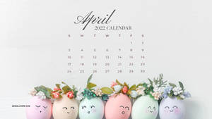 2022年4月日曆，帶有微笑的柔和蛋，以花朵裝飾。