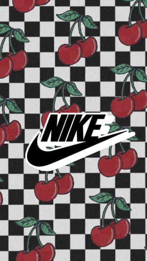 Nike標誌居中於黑白棋盤格圖案，配有紅色櫻桃和綠色葉子。 — 型格 Nike 壁紙