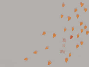 橙色心形對角飄浮，灰色背景上寫有「fall in love」。