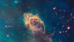一個發光的星雲，帶有橙色和藍綠色的雲團，被深空中的星星環繞。