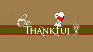 史努比拿著一顆紅心，旁邊有「Be THANKFUL」文字和小麥稈。