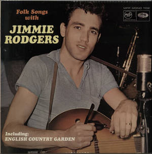 Jimmie Rodgers 在復古錄音室中拿著結他，旁邊有麥克風和專輯文字。 — Galaxy Z Flip7 FE 壁紙