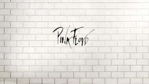 白色磚牆上黑色草書的Pink Floyd標誌。