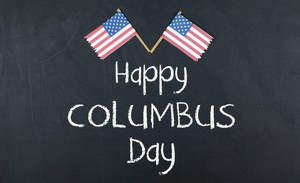 黑板上有交叉的美國國旗和粉筆寫的「Happy Columbus Day」。