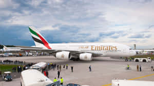 阿聯酋航空A380在機場停機坪，周圍有人群和車輛。